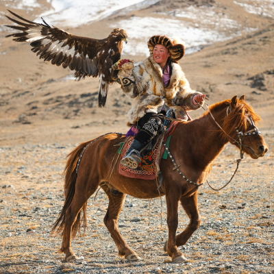 Women on horse holding eagle