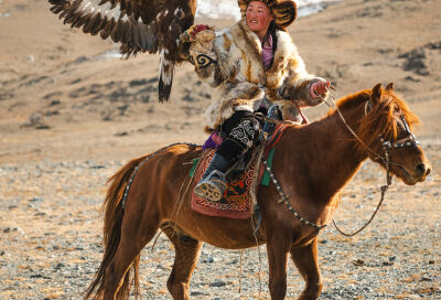 Women on horse holding eagle